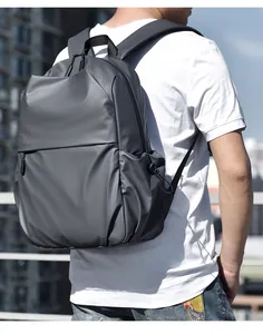 Macro detail of dark grey laptop backpack showing waterproof fabric and adjustable side straps