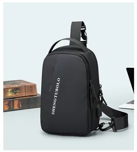 Detail of black sports chest bag showing USB charging port and logo on nylon fabric