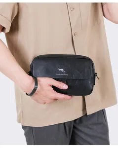 Close-up of a black leather crossbody bag for men with a kangaroo logo and brand text