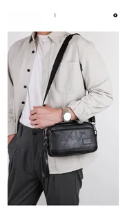Model wearing a black minimalist crossbody bag with adjustable strap and metal HCDS logo