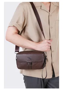 Detail of dark brown leather crossbody bag with textured pebble finish and adjustable strap