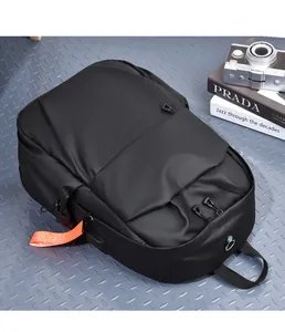 Detail of waterproof nylon backpack with USB charging port and orange strap accents