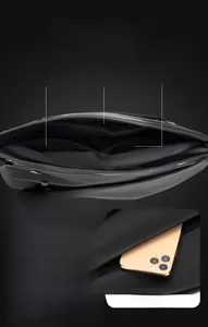 Detail of waterproof nylon crossbody bag showing multi-pocket storage for phone and keys