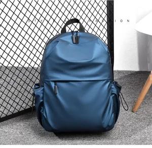 Detail of dark blue waterproof backpack featuring hidden zipper pocket and side drawstring pockets