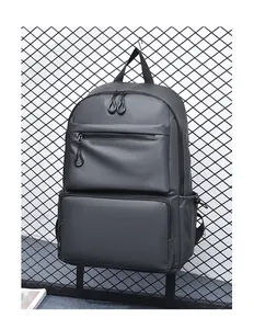 Close-up of a charcoal grey water-resistant backpack with circular zipper pull details
