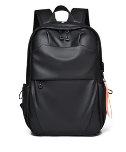 Detail view of black business laptop backpack showing waterproof fabric and USB charging port