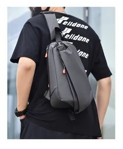 Detail showing water-resistant fabric and tactical buckle on a black crossbody bag