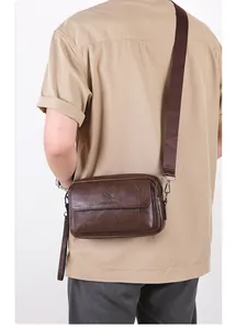 Detail of vintage brown crossbody bag featuring pebble grain texture and kangaroo logo