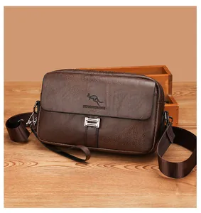 Detailed view of dark brown leather texture with silver metal buckle on a men's messenger bag