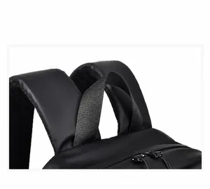 Detail of the reinforced leather handle and stitching on the top of the black backpack