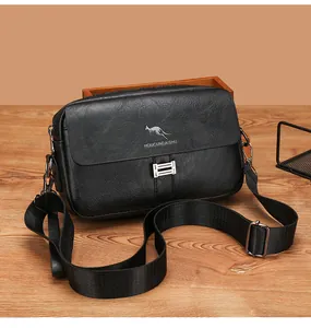 Detail of black textured leather crossbody bag with silver logo and metallic buckle