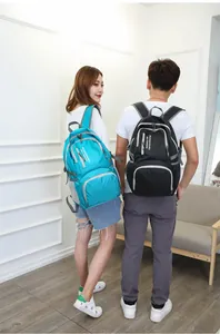 Outdoor foldable backpack shown on male and female models with side mesh pockets