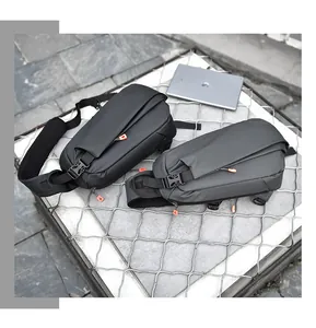 Waterproof urban crossbody bags in black and grey with bright orange zipper details