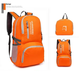 Detail view of orange folding backpack showing main compartment and compact storage