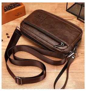 Detailed view of brown vintage texture leather bag with multi-layer zippers and logo