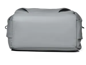 Close-up of water-resistant grey backpack bottom showing durable stitching and cross-texture