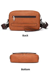 Detail view of the brown leather crossbody bag showing the back zipper and flat bottom