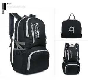 Foldable black hiking backpack detail showing multiple zip pockets and mesh side pockets
