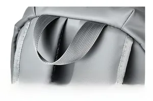 Close-up of durable reinforced top handle and gray mesh fabric on a business backpack