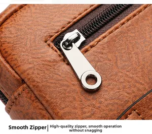 Detail of smooth silver zipper and lychee texture brown leather on men crossbody bag
