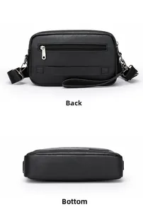 Detailed view of black faux leather handbag showing back zipper and strap metal buckle