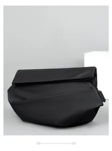Detail shot of black matte waterproof messenger bag with unique geometric folding design