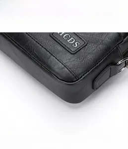 Close-up showing the pebbled leather texture and precision stitching of the men's handbag