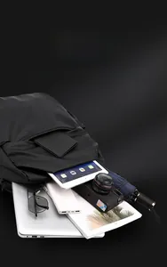 Detailed interior storage showing space for laptop and electronics in black nylon backpack