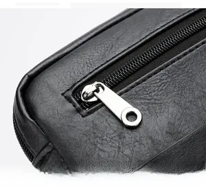 Close-up of smooth silver metal zipper on premium black leather texture crossbody bag