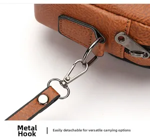 Detail of brown faux leather bag showing textured surface and detachable metal hook