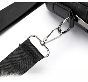 Close-up of detachable silver metal hook and black lychee grain leather on bag