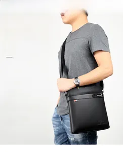 Close-up of black pebble-grain leather business briefcase featuring a classic metal logo