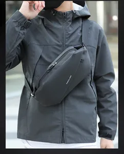 Outdoor model wearing black waterproof chest bag with adjustable strap and white logo
