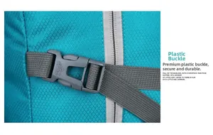 Detail of blue ripstop fabric with a grey plastic buckle on a foldable hiking backpack