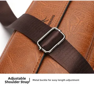 Detail of adjustable shoulder strap with silver metal buckle on brown lychee leather bag