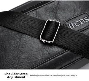 Detail of adjustable shoulder strap with silver metal buckle on textured black leather bag