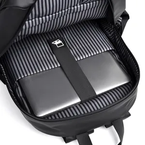 Minimalist black backpack showing spacious main compartment with striped laptop sleeve
