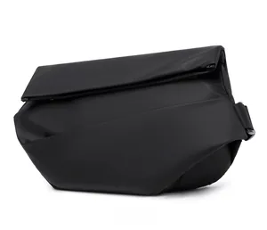 Side view of minimalist black crossbody bag showing matte waterproof texture and fold design