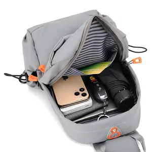 Waterproof light grey Oxford crossbody chest bag for men showing large inner capacity