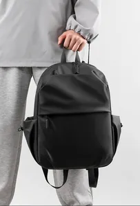 Minimalist black waterproof travel backpack featuring matte texture and hidden zipper pocket