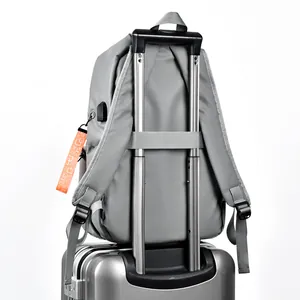 Minimalist gray business laptop backpack with luggage strap and integrated USB charging port