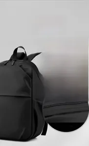 Detail view showing the durable dual zippers and water-resistant fabric of the black backpack