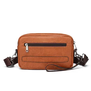 Brown faux leather crossbody bag for men with textured finish and adjustable shoulder strap