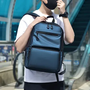 Deep blue water-resistant men's backpack for travel and business shown in modern outdoor setting