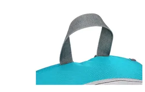 Detail of reinforced gray handle and blue diamond ripstop fabric on folding backpack
