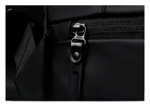 Close-up of premium SBS metal zipper and leather puller on waterproof black crossbody bag