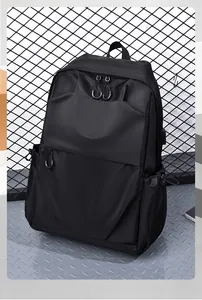 Detail of minimalist black business backpack with external USB charging port interface