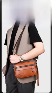 Detail view of caramel brown faux leather texture and metal zipper on men's crossbody bag