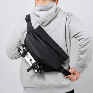 Waterproof matte black motorcycle crossbody bag with tripod straps worn by a male model