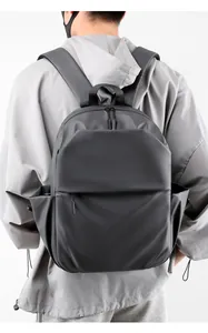 Detail view of a minimalist dark grey laptop backpack with waterproof matte texture fabric